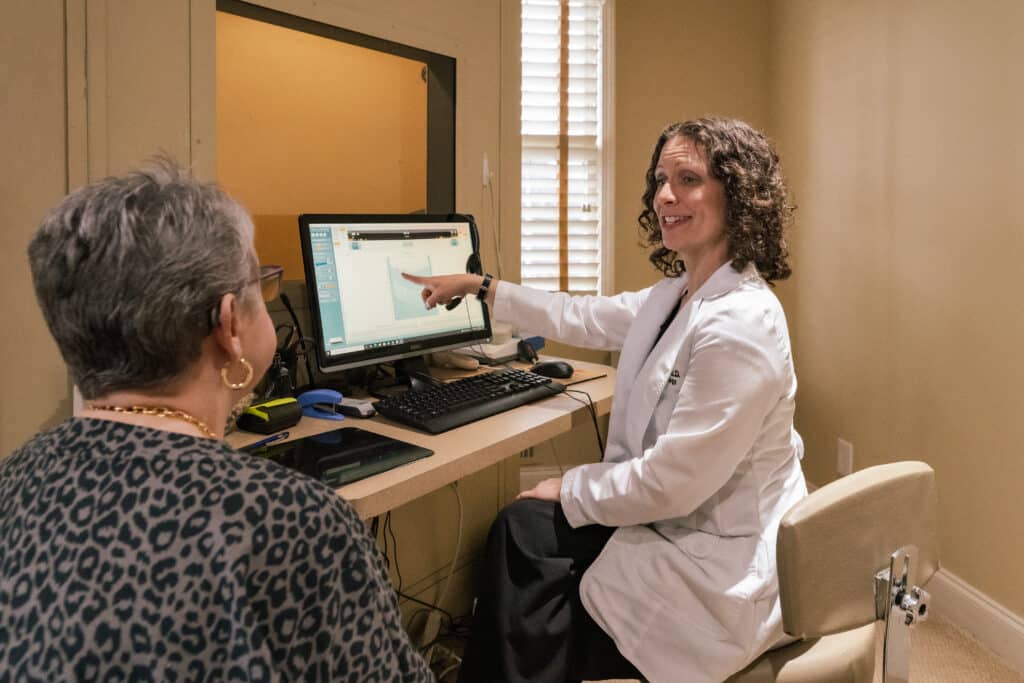 Audiologist reviewing a patients hearing exam results